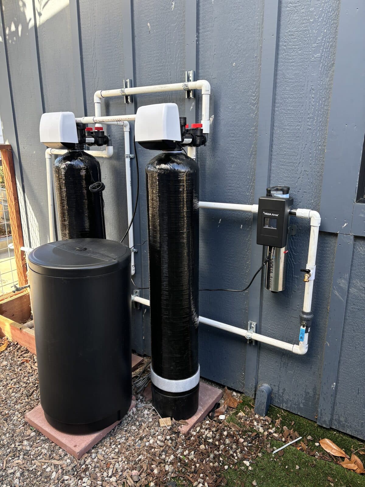 Water treatment tanks and piping against a building